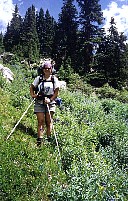 Koren hiking next to a wonderful patch of wild flowers.